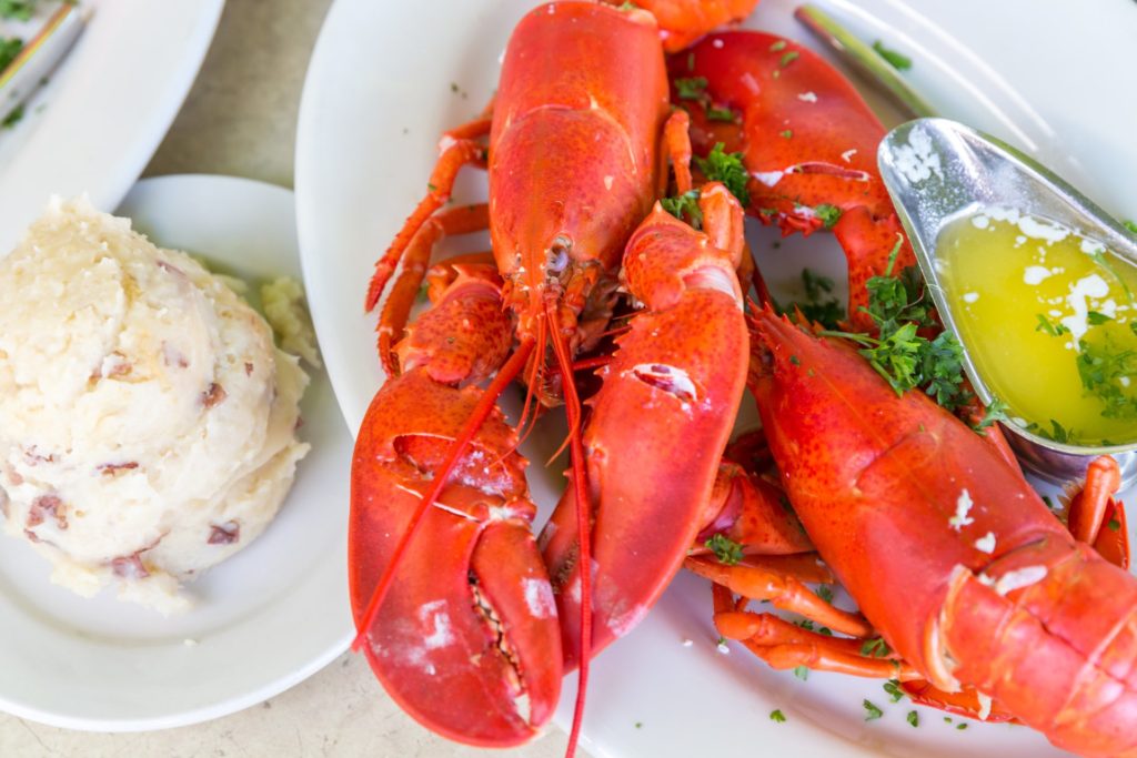 Lobster on plate with butter and side dishes
