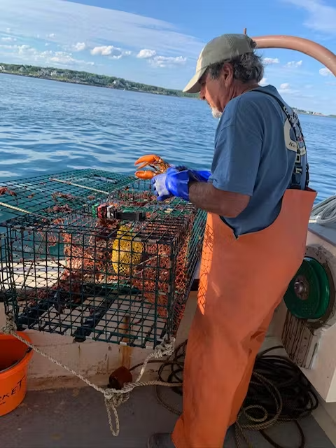 Image of man working on lobster boat